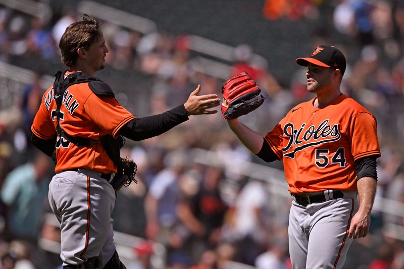 Jul 8, 2023; Minneapolis, Minnesota, USA;  Baltimore Orioles catcher Adley Rutschman (35) and pitcher Danny Coulombe (54) celebrate a victory over the Minnesota Twins at Target Field. Mandatory Credit: Nick Wosika-USA TODAY Sports