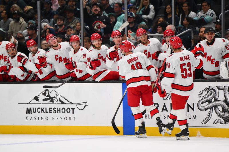 Oct 26, 2024; Seattle, Washington, USA; Carolina Hurricanes center Jack Drury (18) celebrates with the bench after scoring a goal against the Seattle Kraken during the second period at Climate Pledge Arena. Mandatory Credit: Steven Bisig-Imagn Images