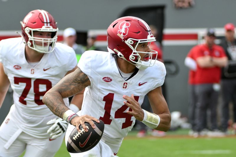 Nov 2, 2024; Raleigh, North Carolina, USA;  Stanford Cardinals quarter back Ashton Daniels (14) runs the ball during the second quarter against North Carolina State Wolfpack at Carter-Finley Stadium. Mandatory Credit: Zachary Taft-Imagn Images