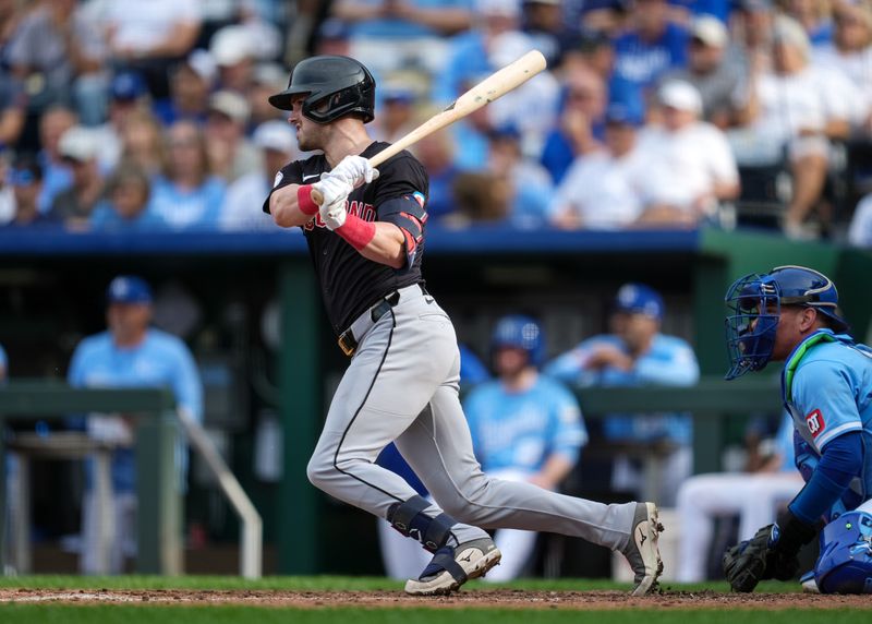 Sep 2, 2024; Kansas City, Missouri, USA; Cleveland Guardians center fielder Lane Thomas (8) hits a double during the ninth inning against the Kansas City Royals at Kauffman Stadium. Mandatory Credit: Jay Biggerstaff-USA TODAY Sports