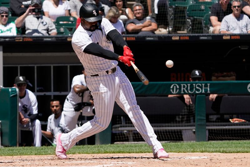 Jun 30, 2024; Chicago, Illinois, USA; Chicago White Sox designated hitter Eloy Jiménez (74) hits a double against the Colorado Rockies during the fourth inning at Guaranteed Rate Field. Mandatory Credit: David Banks-USA TODAY Sports