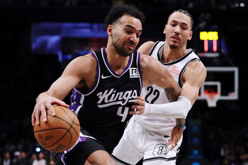 NEW YORK, NEW YORK - JANUARY 27: Trey Lyles #41 of the Sacramento Kings dribbles against Jalen Wilson #22 of the Brooklyn Nets during the second half at Barclays Center on January 27, 2025 in the Brooklyn borough of New York City. The Kings won 110-96. NOTE TO USER: User expressly acknowledges and agrees that, by downloading and or using this photograph, User is consenting to the terms and conditions of the Getty Images License Agreement. (Photo by Sarah Stier/Getty Images)