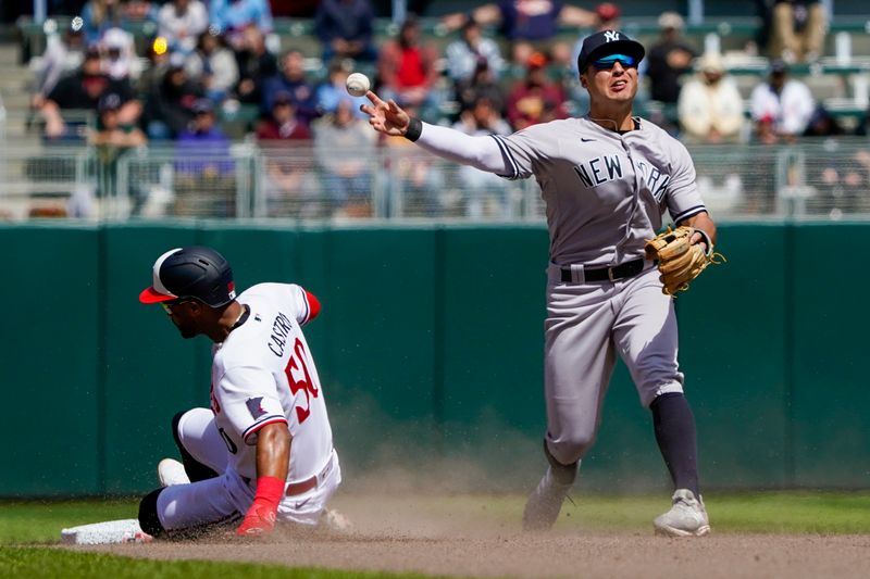 Apr 26, 2023; Minneapolis, Minnesota, USA; New York Yankees infielder Anthony Volpe (11) throws to first over a sliding Minnesota Twins outfielder Willi Castro (50) but is unable to complete the double play during the seventh inning at Target Field. Mandatory Credit: Nick Wosika-USA TODAY Sports

