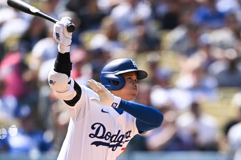 Apr 20, 2024; Los Angeles, California, USA; Los Angeles Dodgers designated hitter Shohei Ohtani (17) doubles against the New York Mets during the fifth inning at Dodger Stadium. Mandatory Credit: Jonathan Hui-USA TODAY Sports