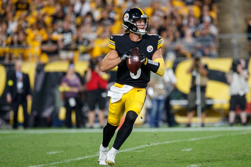 Pittsburgh Steelers quarterback Kenny Pickett (8) rolls out to pass during a preseason NFL football game, Saturday, Aug. 13, 2022, in Pittsburgh, PA. (AP Photo/Matt Durisko)