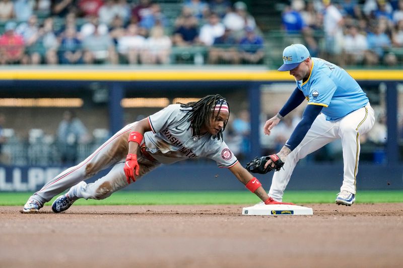 Jul 12, 2024; Milwaukee, Wisconsin, USA;  Washington Nationals shortstop CJ Abrams (5) steals second base before Milwaukee Brewers second baseman Brice Turang (2) can apply the tag during the first inning at American Family Field. Mandatory Credit: Jeff Hanisch-USA TODAY Sports