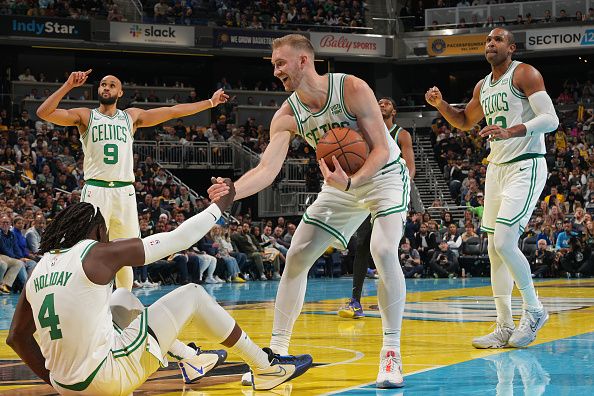INDIANAPOLIS, IN - DECEMBER 4: Sam Hauser #30 of the Boston Celtics helps up Jrue Holiday #4 during the game against the Indiana Pacers during the quarterfinals of the In-Season Tournament on December 4, 2023 at Gainbridge Fieldhouse in Indianapolis, Indiana. NOTE TO USER: User expressly acknowledges and agrees that, by downloading and or using this Photograph, user is consenting to the terms and conditions of the Getty Images License Agreement. Mandatory Copyright Notice: Copyright 2023 NBAE (Photo by Jesse D. Garrabrant/NBAE via Getty Images)