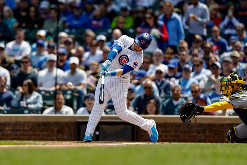 May 3, 2024; Chicago, Illinois, USA; Chicago Cubs outfielder Ian Happ (8) singles against the Milwaukee Brewers during the first inning at Wrigley Field. Mandatory Credit: Kamil Krzaczynski-USA TODAY Sports