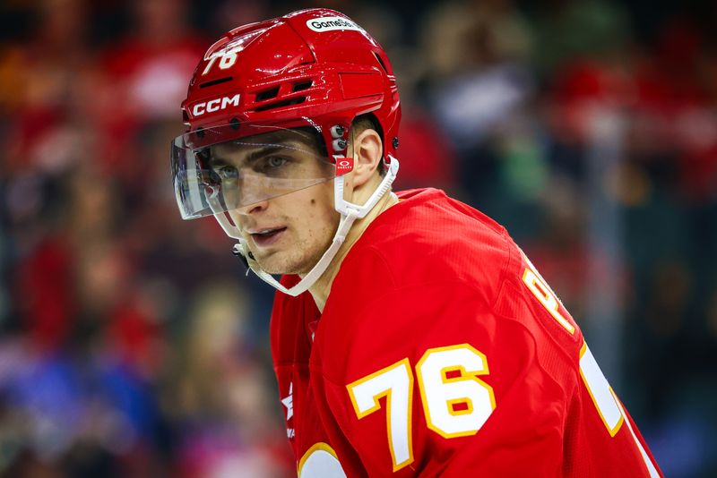 Oct 4, 2024; Calgary, Alberta, CAN; Calgary Flames center Martin Pospisil (76) during the face off against the Winnipeg Jets during the second period at Scotiabank Saddledome. Mandatory Credit: Sergei Belski-Imagn Images