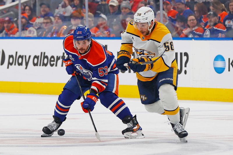 Jan 6, 2026; Edmonton, Alberta, CAN; Edmonton Oilers forward Issac Howard (53) and Nashville Predators forward Michael Bunting (58) chase a loose puck during the third period at Rogers Place. Mandatory Credit: Perry Nelson-Imagn Images