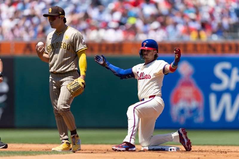 Jun 19, 2024; Philadelphia, Pennsylvania, USA; Philadelphia Phillies second base Bryson Stott (5) reacts in front of San Diego Padres shortstop Ha-Seong Kim (7) after hitting a double during the first inning at Citizens Bank Park. Mandatory Credit: Bill Streicher-USA TODAY Sports