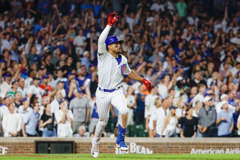 Aug 16, 2023; Chicago, Illinois, USA; Chicago Cubs second baseman Christopher Morel (5) watches his three-run walk-off home run against the Chicago White Sox during the ninth inning at Wrigley Field. Mandatory Credit: Kamil Krzaczynski-USA TODAY Sports