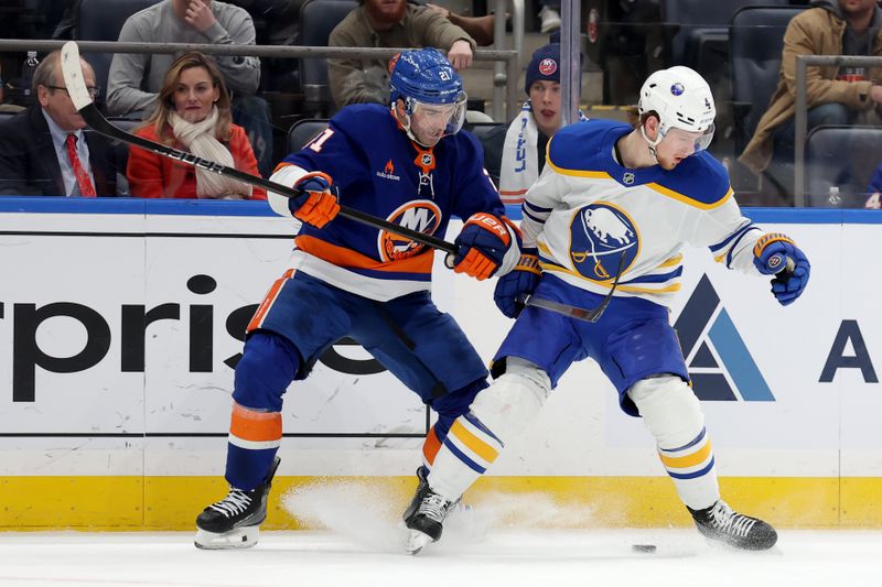 Nov 30, 2024; Elmont, New York, USA; New York Islanders center Kyle Palmieri (21) and Buffalo Sabres defenseman Bowen Byram (4) fight for the puck during the second period at UBS Arena. Mandatory Credit: Brad Penner-Imagn Images