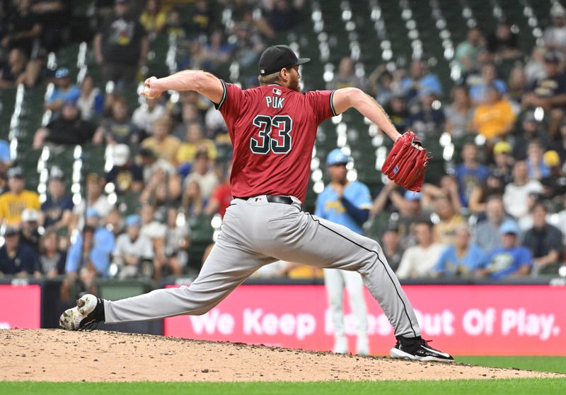 Sep 20, 2024; Milwaukee, Wisconsin, USA; Arizona Diamondbacks pitcher A.J. Puk (33) delivers a pitch against the Milwaukee Brewers in the ninth inning at American Family Field. Mandatory Credit: Michael McLoone-Imagn Images