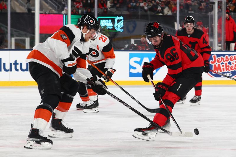 Feb 17, 2024; East Rutherford, New Jersey, USA; New Jersey Devils center Jack Hughes (86) skates with the puck against the Philadelphia Flyers during the second period in a Stadium Series ice hockey game at MetLife Stadium. Mandatory Credit: Ed Mulholland-USA TODAY Sports