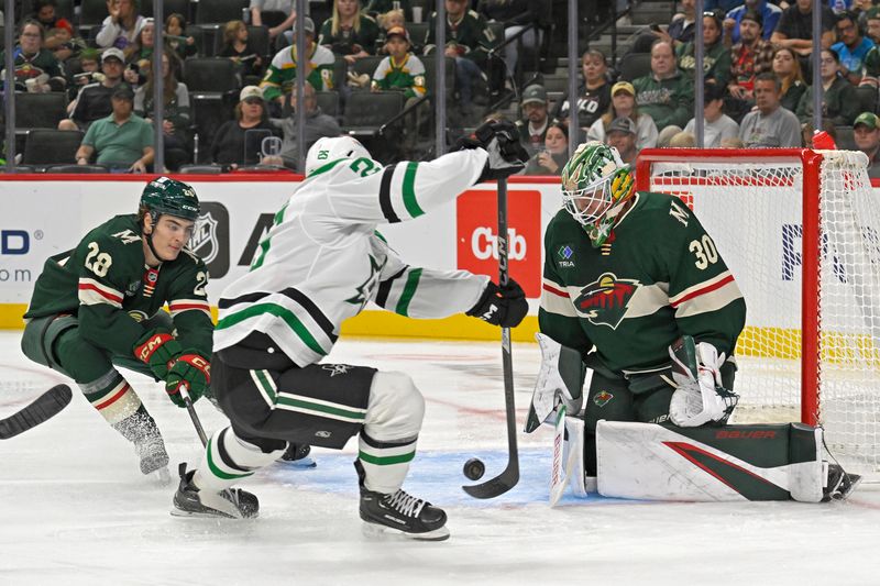 Sep 29, 2024; Saint Paul, Minnesota, USA;  Minnesota Wild goalie Jesper Wallstedt (30) makes a save on Dallas Stars forward Matej Blumel (25) during the first period at Xcel Energy Center. Mandatory Credit: Nick Wosika-Imagn Images