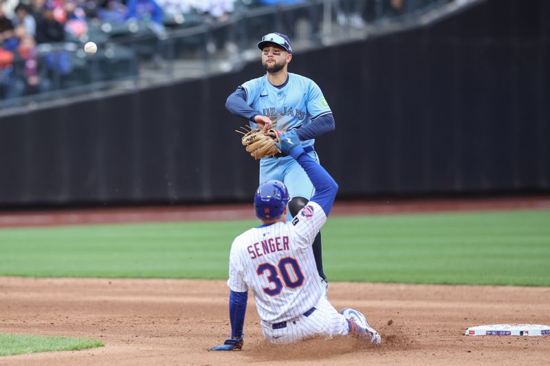 Apr 6, 2025; New York City, New York, USA;  Toronto Blue Jays shortstop Bo Bichette (11) throws past New York Mets catcher Hayden Senger (30) to complete a double play in the fifth inning at Citi Field. Mandatory Credit: Wendell Cruz-Imagn Images