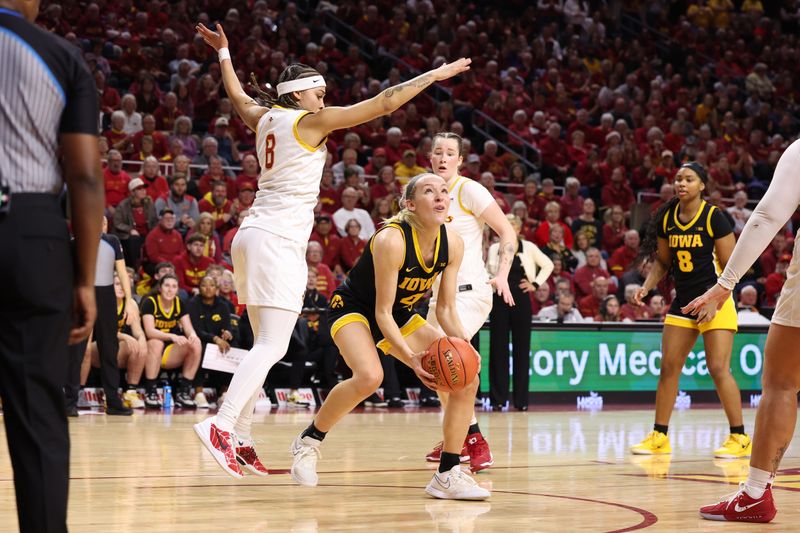 Dec 10, 2025; Ames, Iowa, USA; Iowa Hawkeyes Kylie Feuerbach (4) is defended by Iowa State Cyclones Jada Williams (8) during the second half at James H. Hilton Coliseum. Mandatory Credit: Reese Strickland-Imagn Images