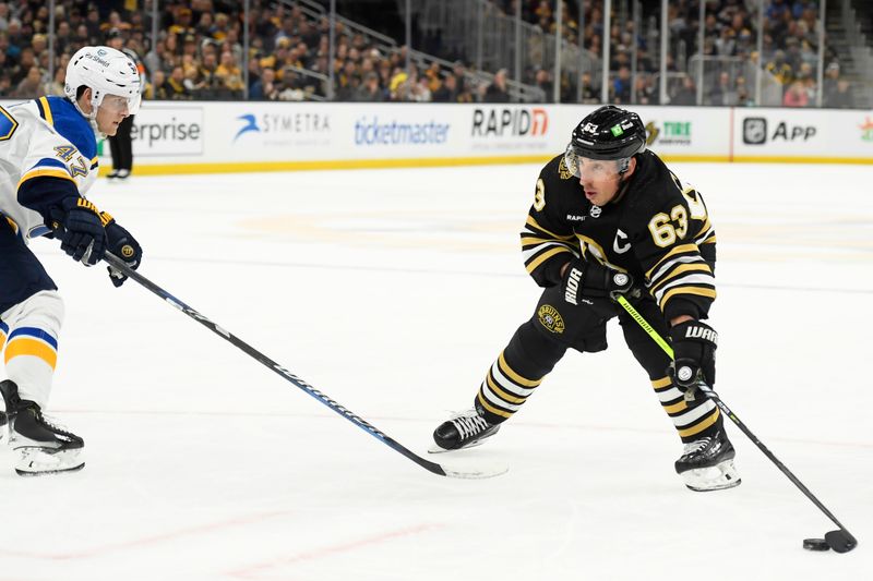 Mar 11, 2024; Boston, Massachusetts, USA;  Boston Bruins left wing Brad Marchand (63) controls the puck while St. Louis Blues defenseman Torey Krug (47) defends during the first period at TD Garden. Mandatory Credit: Bob DeChiara-USA TODAY Sports