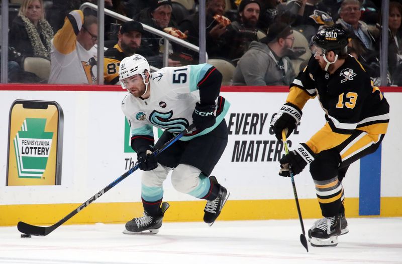 Jan 14, 2025; Pittsburgh, Pennsylvania, USA;  Seattle Kraken center Shane Wright (51) skates with the puck as Pittsburgh Penguins right wing Kevin Hayes (13) chases during the second period at PPG Paints Arena. Mandatory Credit: Charles LeClaire-Imagn Images