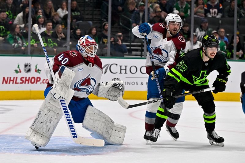 Nov 29, 2024; Dallas, Texas, USA; Colorado Avalanche goaltender Alexandar Georgiev (40) and defenseman Samuel Girard (49) and Dallas Stars center Mavrik Bourque (22) look for the puck during the second period at the American Airlines Center. Mandatory Credit: Jerome Miron-Imagn Images