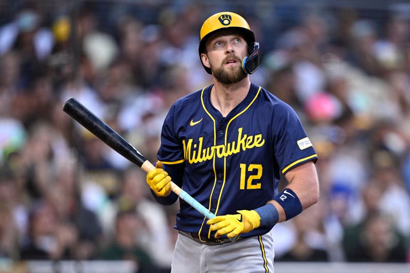 Jun 21, 2024; San Diego, California, USA; Milwaukee Brewers first baseman Rhys Hoskins (12) watches a foul ball during the fourth inning against the San Diego Padres at Petco Park. Mandatory Credit: Orlando Ramirez-USA TODAY Sports