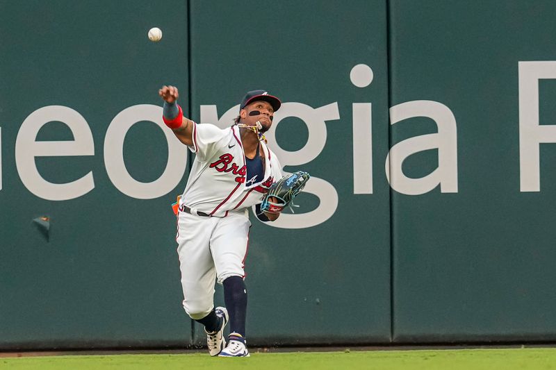 Sep 6, 2023; Cumberland, Georgia, USA; Atlanta Braves right fielder Ronald Acuna Jr. (13) throws out St. Louis Cardinals designated hitter Alec Burleson (41) (not shown) at second base during the first inning at Truist Park. Mandatory Credit: Dale Zanine-USA TODAY Sports