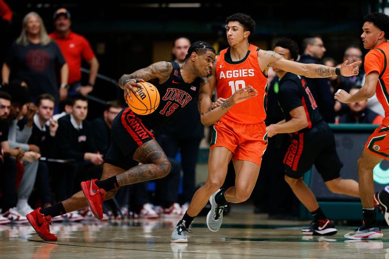 Jan 19, 2024; Fort Collins, Colorado, USA; UNLV Rebels guard Luis Rodriguez (15) controls the ball against Colorado State Rams guard Nique Clifford (10) in the second half at Moby Arena. Mandatory Credit: Isaiah J. Downing-USA TODAY Sports