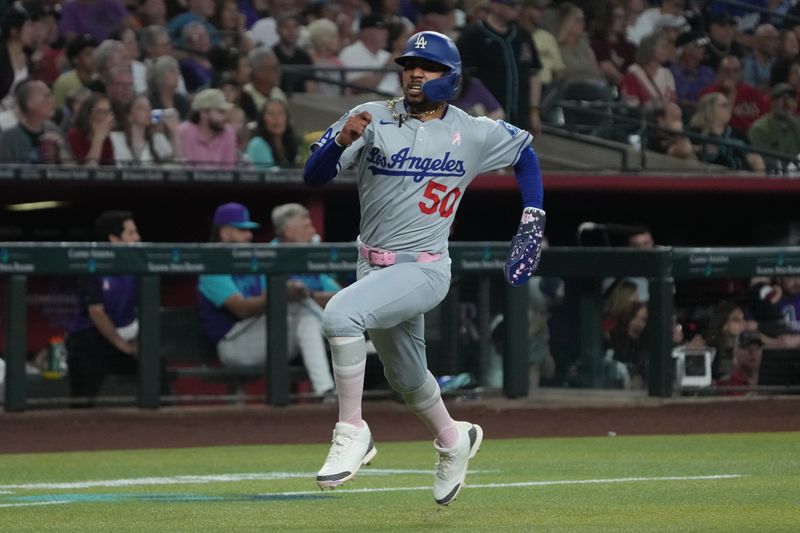 May 11, 2025; Phoenix, Arizona, USA; Los Angeles Dodgers shortstop Mookie Betts (50) scores a run against the Arizona Diamondbacks in the first inning at Chase Field. Mandatory Credit: Rick Scuteri-Imagn Images