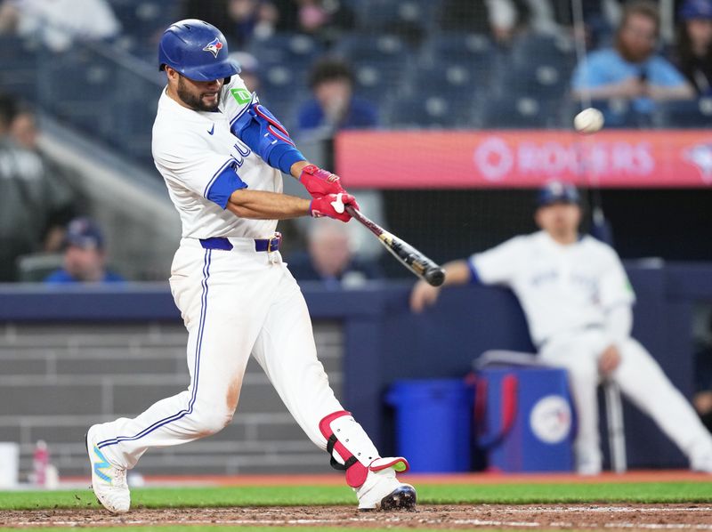 Apr 12, 2024; Toronto, Ontario, CAN; Toronto Blue Jays third baseman Isiah Kiner-Falefa (7) hits a home run against the Colorado Rockies during the ninth inning at Rogers Centre. Mandatory Credit: Nick Turchiaro-USA TODAY Sports