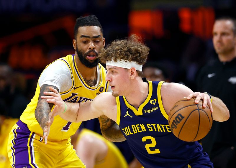 LOS ANGELES, CALIFORNIA - APRIL 09:  Brandin Podziemski #2 of the Golden State Warriors controls the ball against D'Angelo Russell #1 of the Los Angeles Lakers in the first half at Crypto.com Arena on April 09, 2024 in Los Angeles, California.  NOTE TO USER: User expressly acknowledges and agrees that, by downloading and/or using this photograph, user is consenting to the terms and conditions of the Getty Images License Agreement.  (Photo by Ronald Martinez/Getty Images)