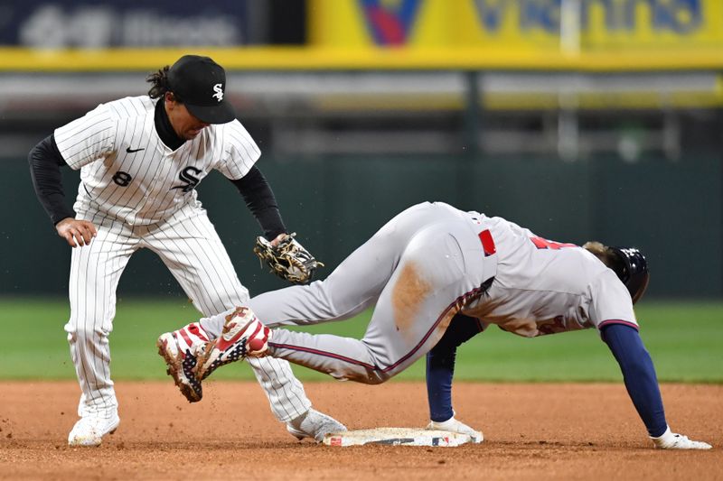 Apr 2, 2024; Chicago, Illinois, USA; Chicago White Sox second baseman Nicky Lopez (8) attempts to tag out Atlanta Braves left fielder Jarred Kelenic (24) during the eighth inning at Guaranteed Rate Field. Mandatory Credit: Patrick Gorski-USA TODAY Sports