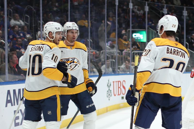 Mar 1, 2025; Elmont, New York, USA;  Nashville Predators left wing Cole Smith (36) celebrates his goal with center Colton Sissons (10) and defenseman Justin Barron (20) against the New York Islanders during the third period at UBS Arena. Mandatory Credit: Thomas Salus-Imagn Images