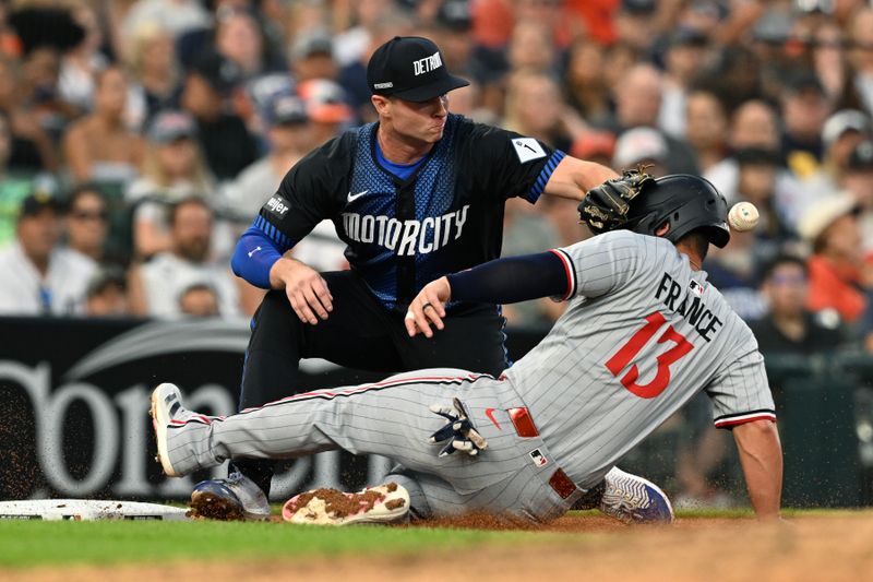 Jun 27, 2025; Detroit, Michigan, USA; Minnesota Twins first base Ty France (13) slides safely into third base as the throw to Detroit Tigers third baseman Colt Keith (33) hits France in the head in the sixth inning at Comerica Park. Mandatory Credit: Lon Horwedel-Imagn Images