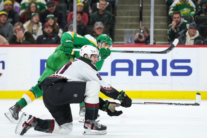 Jan 13, 2024; Saint Paul, Minnesota, USA; Minnesota Wild left wing Marcus Johansson (90) shoots as Arizona Coyotes defenseman J.J. Moser (90) defends during the third period at Xcel Energy Center. Mandatory Credit: Matt Krohn-USA TODAY Sports