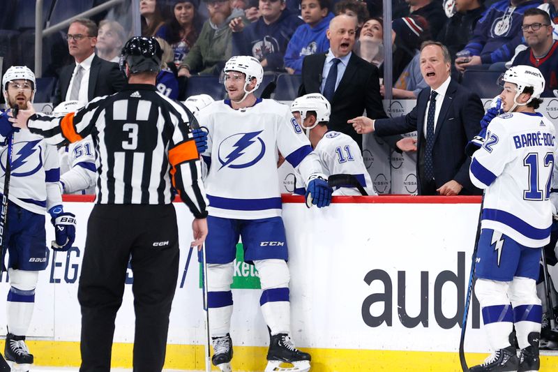 Jan 2, 2024; Winnipeg, Manitoba, CAN; Tampa Bay Lightning head coach Jon Cooper talks about a call with referee Chris Schlenker (3) in the first period against the Winnipeg Jets at Canada Life Centre. Mandatory Credit: James Carey Lauder-USA TODAY Sports