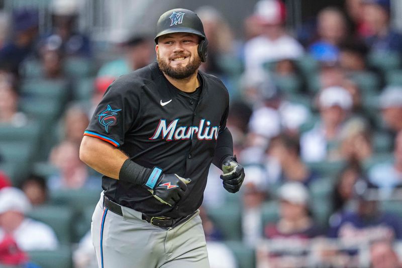 Aug 2, 2024; Cumberland, Georgia, USA; Miami Marlins designated hitter Jake Burger (36) reacts after hitting a home run against the Atlanta Braves during the third inning at Truist Park. Mandatory Credit: Dale Zanine-USA TODAY Sports