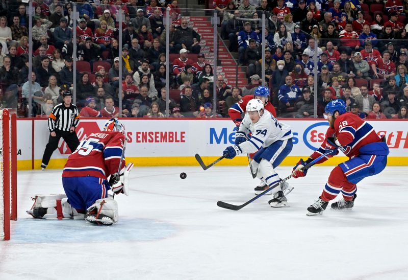 Mar 9, 2024; Montreal, Quebec, CAN; Montreal Canadiens goalie Sam Montembeault (35) stops Toronto Maple Leafs forward Bobby McMann (74) during the third period at the Bell Centre. Mandatory Credit: Eric Bolte-USA TODAY Sports