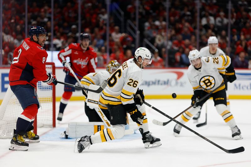 Oct 8, 2025; Washington, District of Columbia, USA; Boston Bruins defenseman Andrew Peeke (26) blocks a shot as Washington Capitals left wing Alex Ovechkin (8) looks on during the third period at Capital One Arena. Mandatory Credit: Geoff Burke-Imagn Images