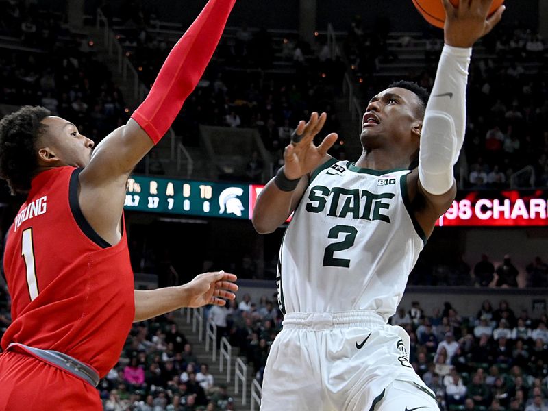 Feb 7, 2023; East Lansing, Michigan, USA; Michigan State Spartans guard Tyson Walker (2) shoots past Maryland Terrapins guard Jahmir Young (1) in the second half at Jack Breslin Student Events Center. Mandatory Credit: Dale Young-USA TODAY Sports