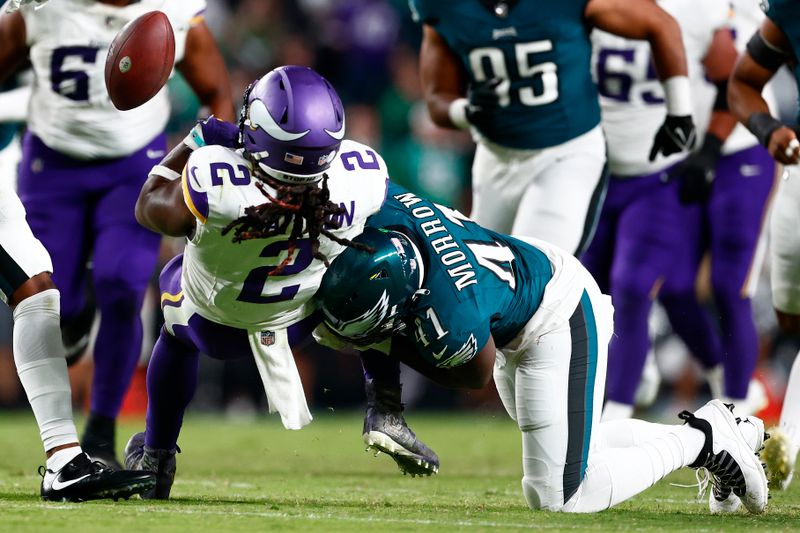 Minnesota Vikings running back Alexander Mattison (2) fumbles as Philadelphia Eagles linebacker Nicholas Morrow (41) tackles him during an NFL football game, Thursday, Sep. 14, 2023, in Philadelphia. (AP Photo/Rich Schultz)