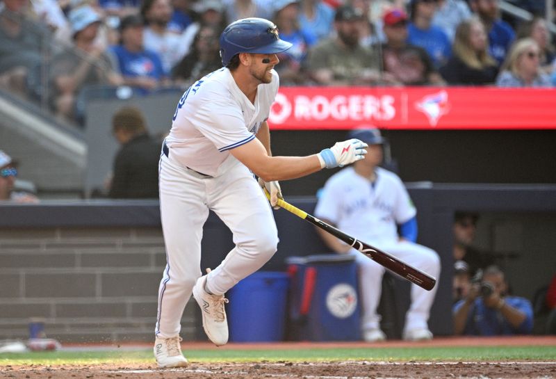 Sep 14, 2024; Toronto, Ontario, CAN;  Toronto Blue Jays shortstop Ernie Clement (28) hits an RBI single against the St. Louis Cardinals in the sixth inning at Rogers Centre. Mandatory Credit: Dan Hamilton-Imagn Images