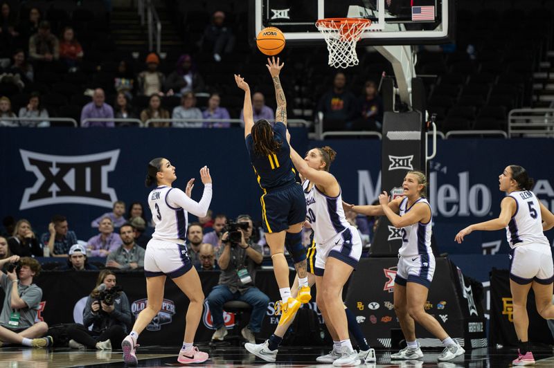 Mar 9, 2024; Kansas City, MO, USA; West Virginia Mountaineers guard JJ Quinerly (11) shoots the ball while defended by Kansas State Wildcats center Ayoka Lee (50) during the second half at T-Mobile Center. Mandatory Credit: Amy Kontras-USA TODAY Sports