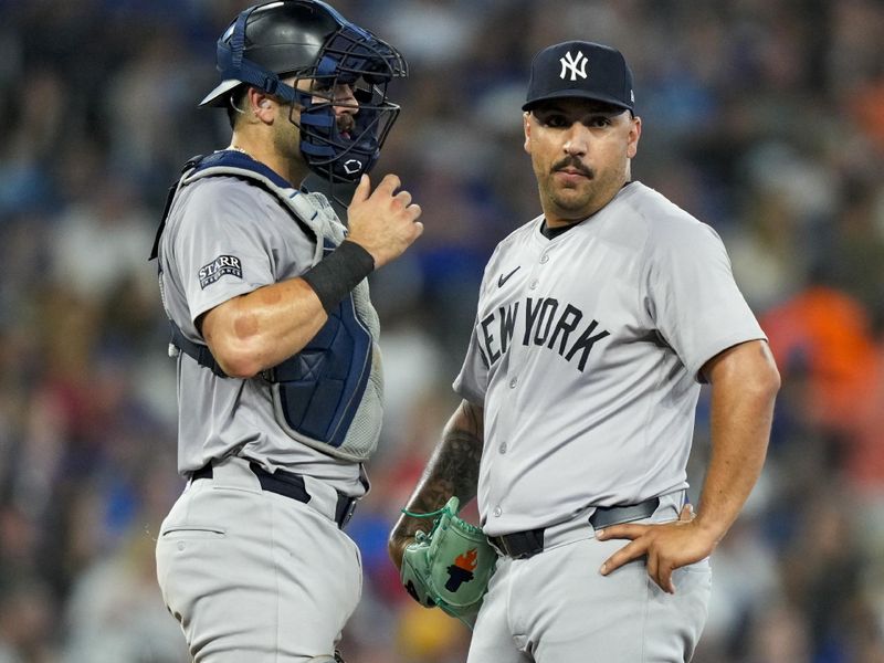 Jun 29, 2024; Toronto, Ontario, CAN; New York Yankees catcher Austin Wells (28) visits pitcher Nestor Cortes (65) during the fourth inning against the Toronto Blue Jays at Rogers Centre. Mandatory Credit: Kevin Sousa-USA TODAY Sports