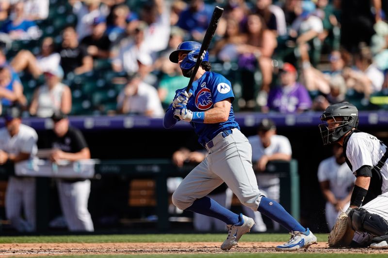 Sep 15, 2024; Denver, Colorado, USA; Chicago Cubs shortstop Dansby Swanson (7) hits a single in the sixth inning against the Colorado Rockies at Coors Field. Mandatory Credit: Isaiah J. Downing-Imagn Images