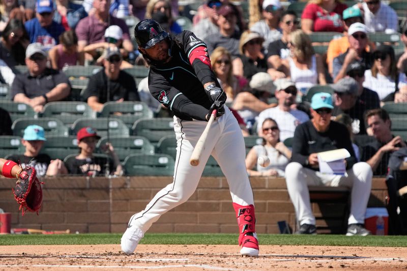 Mar 8, 2024; Salt River Pima-Maricopa, Arizona, USA; Arizona Diamondbacks third baseman Eugenio Suarez (28) hits a single against the Chicago Cubs in the second inning at Salt River Fields at Talking Stick. Mandatory Credit: Rick Scuteri-USA TODAY Sports