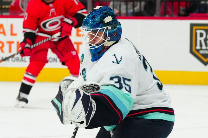 Oct 26, 2023; Raleigh, North Carolina, USA; Seattle Kraken goaltender Joey Daccord (35) makes a glove save against the Carolina Hurricanes during the first period at PNC Arena. Mandatory Credit: James Guillory-USA TODAY Sports