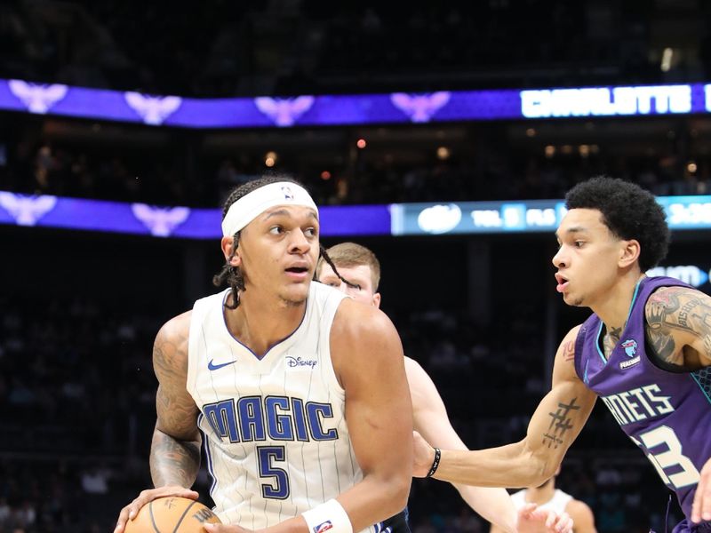 CHARLOTTE, NC - MARCH 5: Paolo Banchero #5 of the Orlando Magic handles the ball during the game against the Charlotte Hornets on March 5, 2024 at Spectrum Center in Charlotte, North Carolina. NOTE TO USER: User expressly acknowledges and agrees that, by downloading and or using this photograph, User is consenting to the terms and conditions of the Getty Images License Agreement.  Mandatory Copyright Notice:  Copyright 2024 NBAE (Photo by Brock Williams-Smith/NBAE via Getty Images)