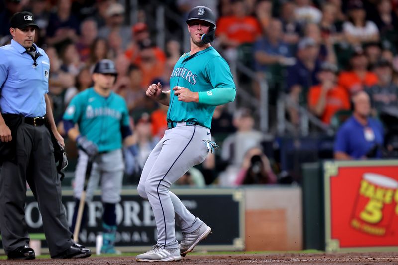 May 4, 2024; Houston, Texas, USA; Seattle Mariners first baseman Ty France (23) crosses home plate to score a run against the Houston Astros during the second inning at Minute Maid Park. Mandatory Credit: Erik Williams-USA TODAY Sports