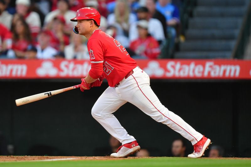 Apr 27, 2024; Anaheim, California, USA; Los Angeles Angels catcher Matt Thaiss (21) hits a single against the Minnesota Twins during the second inning at Angel Stadium. Mandatory Credit: Gary A. Vasquez-USA TODAY Sports